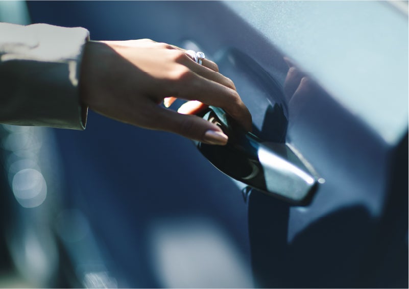 A hand gracefully grips the Light Touch Handle of a 2023 Lincoln Aviator® SUV to demonstrate its ease of use | George Ballentine Lincoln in Greenwood SC