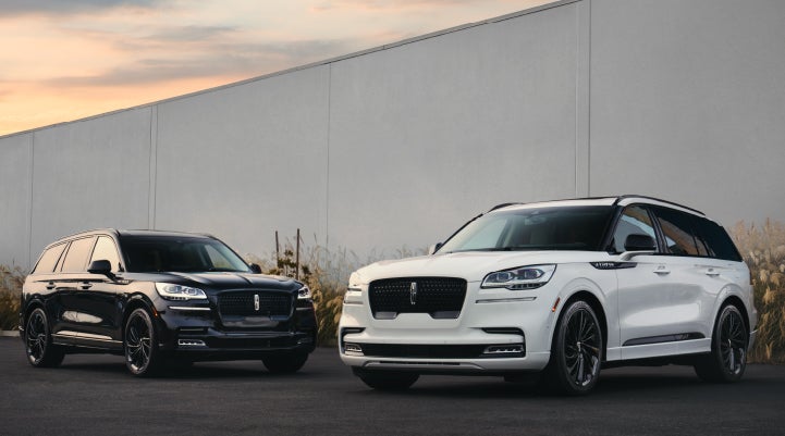 Two Lincoln Aviator® SUVs are shown with the available Jet Appearance Package | George Ballentine Lincoln in Greenwood SC