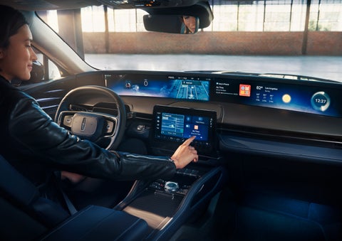 The driver of a 2024 Lincoln Nautilus® SUV interacts with the center touchscreen. | George Ballentine Lincoln in Greenwood SC